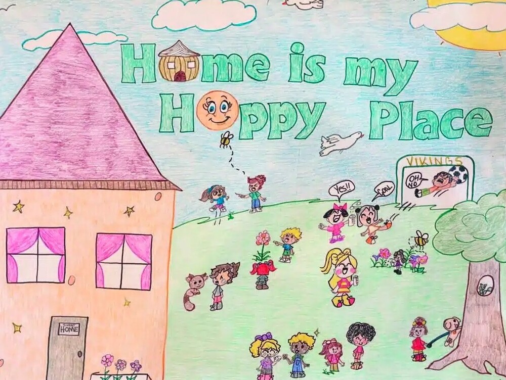 What Home Means to Me Poster Contest Winner, August 2024. Home is my Happy Place. A large group of children in between a house and a tree with a squirrel in it playing and happy.