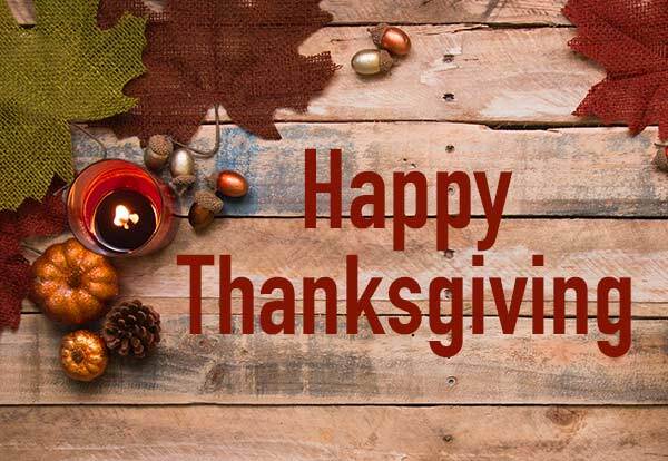 Happy Thanksgiving. Autumn leaves, gourds, and nuts on a wooden background. 